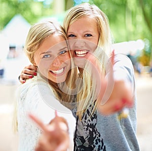 Peace hands, portrait and women friends hug in a park with freedom, fun and bonding in nature together. V sign, face and