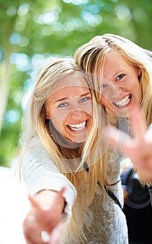 Peace, hands and women portrait in a park for fun, adventure or bonding outdoor together. V, sign or face of friends in