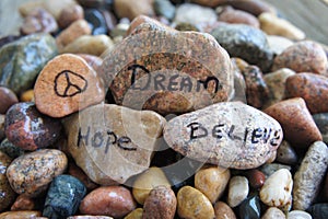 Peace, Hope, Dream and Believe Handwritten on River Rock