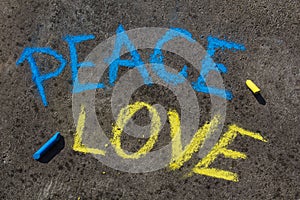 PEACE, LOVE inscription. Chalk drawing on sidewalk.