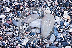 Peace and Love symbols on rocks
