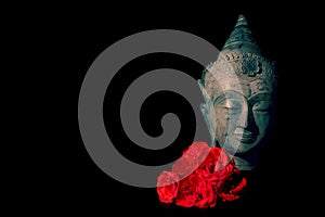 Peace and love. Traditional meditating Buddha head with red roses