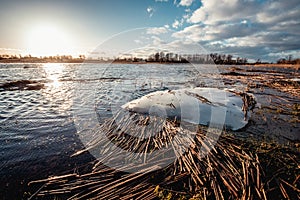 The peace of melting ice floating in flooded spring river