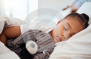 Peace, morning and wellness of black child sleeping in cozy bed with toy teddy in home on the weekend. Relax, sleep and