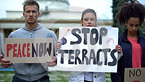 Peace now and stop terracts, people holding signs, protest against terrorism