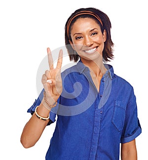 Peace out. An attractive young woman giving you the peace sign while isolated on white.