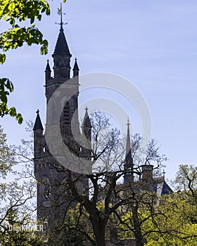 Peace Palace behind a woodland, Vredespaleis, under a pure gradient blue sky, seat of the ICJ, International Court of Justice,