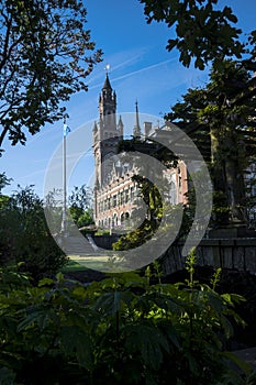 Peace Palace behind a woodland, Vredespaleis, under a pure gradient blue sky, seat of the ICJ, International Court of Justice, photo