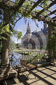 Peace Palace, Vredespaleis, from the pond bridge framed by wisteria blossom