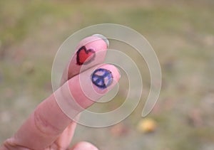 Peace sign and heart shape drawings crossed fingers