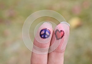 Peace sign and heart shape drawings on fingers