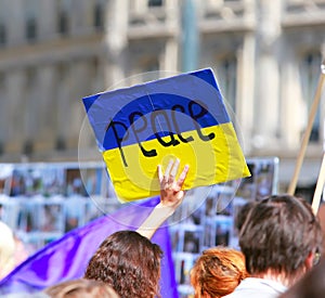 Peace sign on the ukrainian flag in protest manifestation against war photo