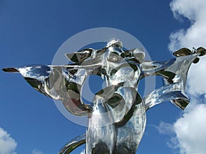 Peace statue in Normandy, France - silver woman holding dove
