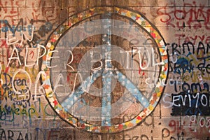 Peace symbol and graffiti spray-painted on wall