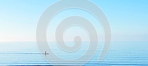 Peace tranquility serene serenity sup paddle boarding on a calm clear blue water ocean sea horizon copyspace