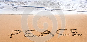 Peace written in sand on beach