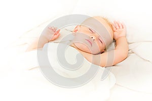 Peaceful baby lying on a bed sleeping