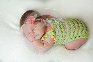 Peaceful baby lying on a bed while sleeping in a bright room