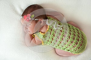 Peaceful baby lying on a bed while sleeping in a bright room