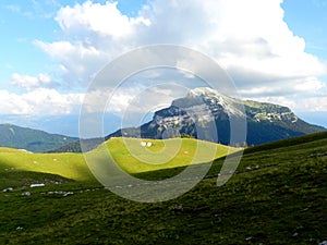 Peaceful landscape, fields and a mountain peak in Charmant Som, France photo