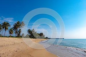 A peaceful beach scene in Thailand, exotic tropical beach landscapes and blue sea under a blue background. Relaxing summer holiday