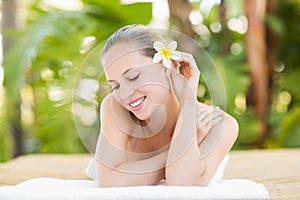 Peaceful blonde lying on towel