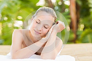 Peaceful blonde lying on towel