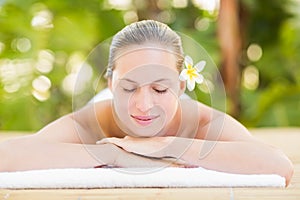 Peaceful blonde lying on towel