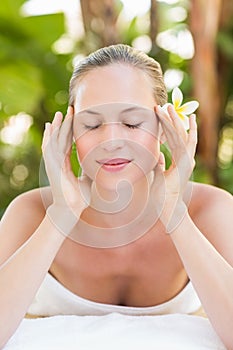 Peaceful blonde lying on towel