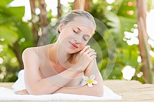 Peaceful blonde lying on towel