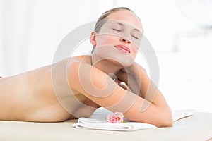 Peaceful blonde lying on towel