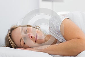 Peaceful blonde woman sleeping in bed