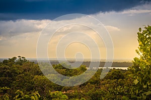 Peaceful blue lake with green grass and blue sky background. Beautiful blue sky and clouds over the reservoir. Rafting activity i