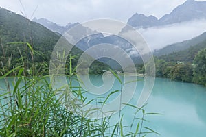 peaceful blue lake with mountain background after rain