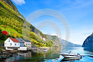 Peaceful boat on fjord in sunny day