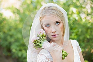Peaceful bride holding her bouquet