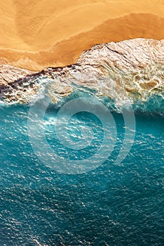 Peaceful bright beach, seaside, vertical view. Drone view of tropical blue ocean beach Nusa penida Bali Indonesia.