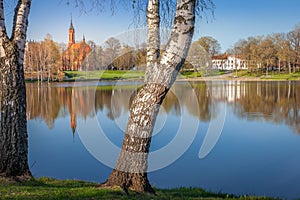Peaceful city park and church on the lake Druskonis reflection, lithuania
