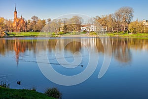 Peaceful city park and church on the lake Druskonis reflection, lithuania