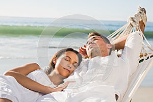 Peaceful couple napping in a hammock