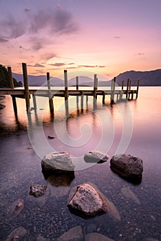 Peaceful Dawn Sky With Wooden Jetty At Derwentwater In The Lake District.