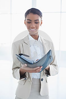 Peaceful elegant businesswoman holding her agenda