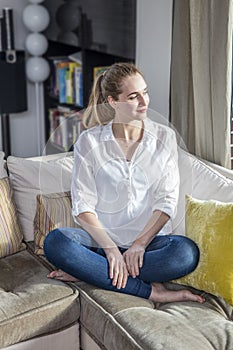 Peaceful gorgeous young woman with crossed legs glowing, enjoying stillness