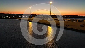 A peaceful harbor or port during sunset view, with road lights and sea water. The harbor is located in Kyllini, near Zakynthos isl