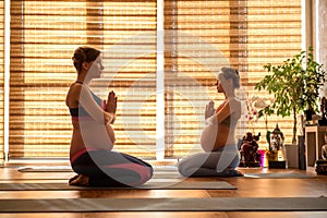 Peaceful impregnate ladies in yoga class