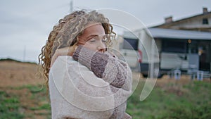 Peaceful lady enjoy cloudy nature standing near modern campervan alone closeup.