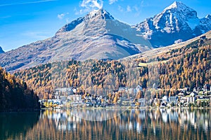 Peaceful lake and town of Saint Moritz on a sunny day in autumn