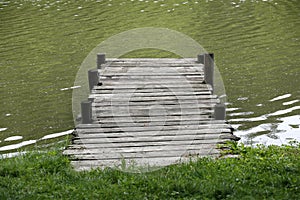 Peaceful lake with weathered rustic vintage jetty