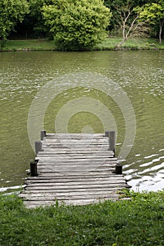 Peaceful lake with weathered rustic vintage jetty