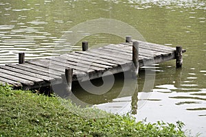 Peaceful lake with weathered rustic vintage jetty